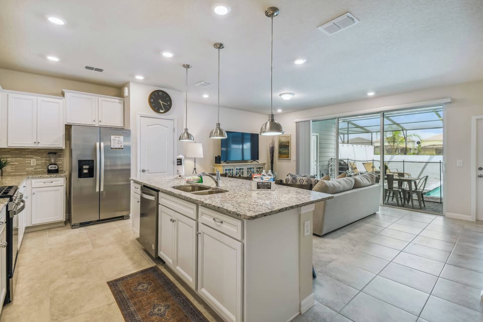 Discover the heart of the home in the spacious kitchen, featuring sleek granite countertops and modern stainless steel appliances that inspire your culinary creativity.