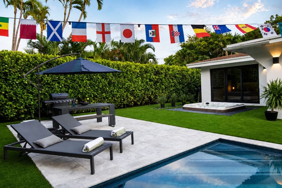 Relax in the private backyard, with amazing pool views day & night and amenities that include soft artificial turf, hot tub, pool lounge chairs, umbrellas, outdoor dining table and a BBQ grill all surrounded by palm trees and tropical landscaping.