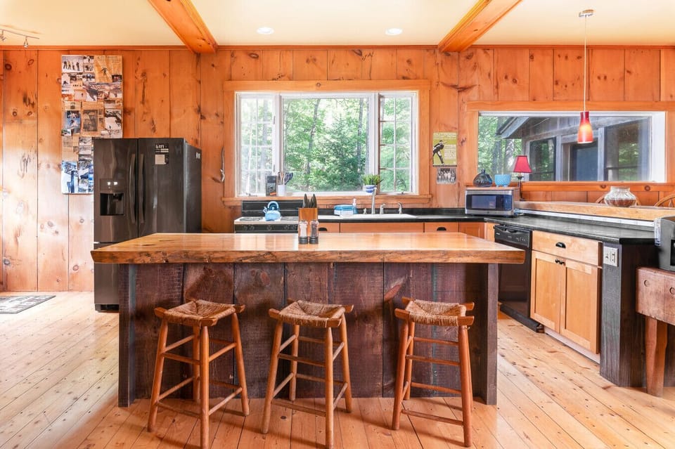 Take in the view from the corner - our kitchen and long wood dining table await!