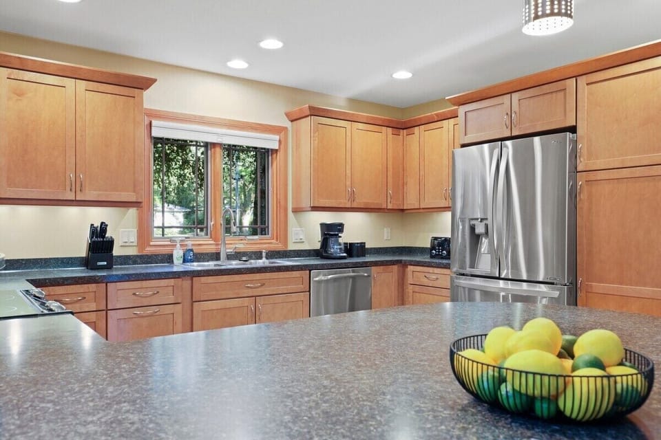 Fully stocked kitchen with barstool seating.