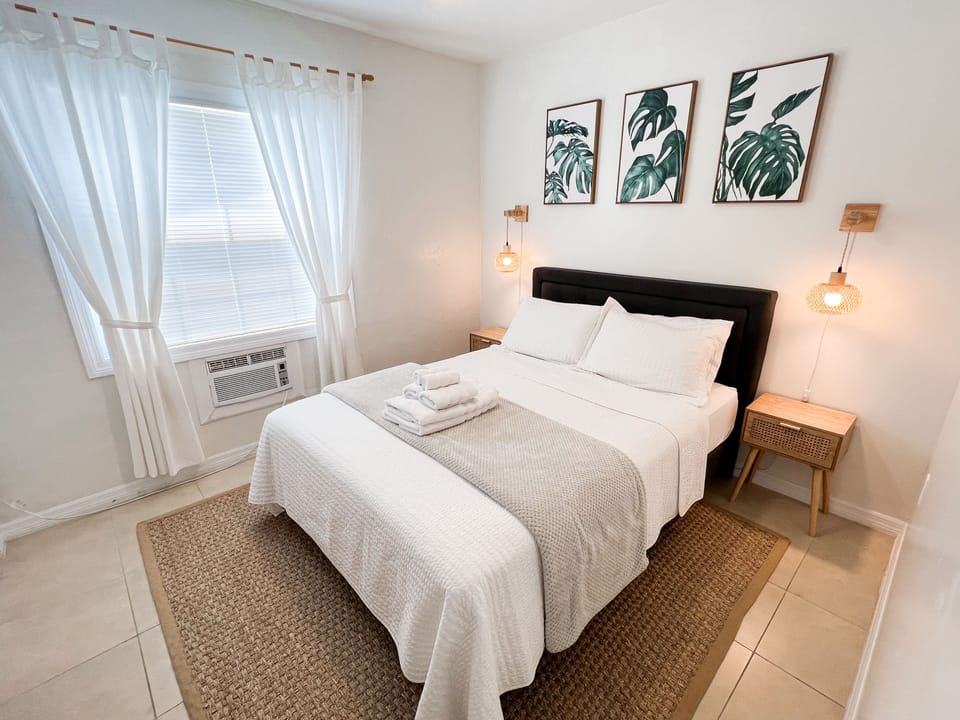 Comfortable queen-size bed with fresh white linens