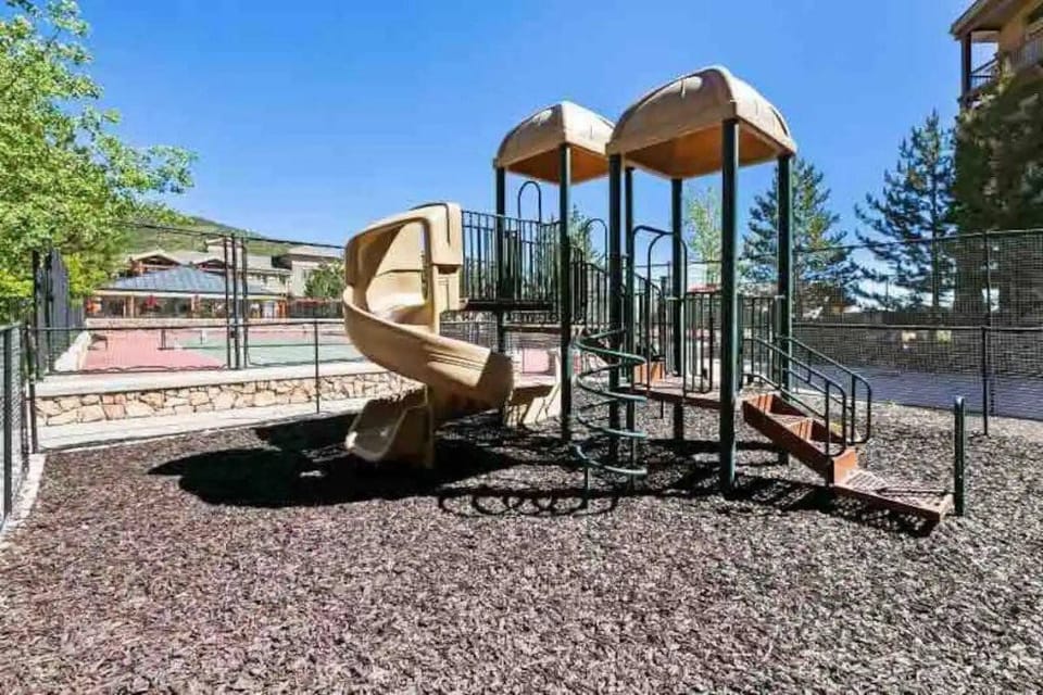 Gated, kids play area, next to gated basketball
