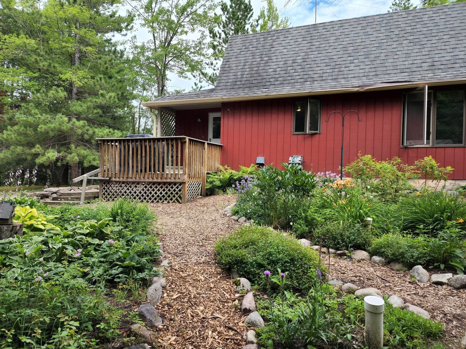 Peaceful perennial gardens surround one side.