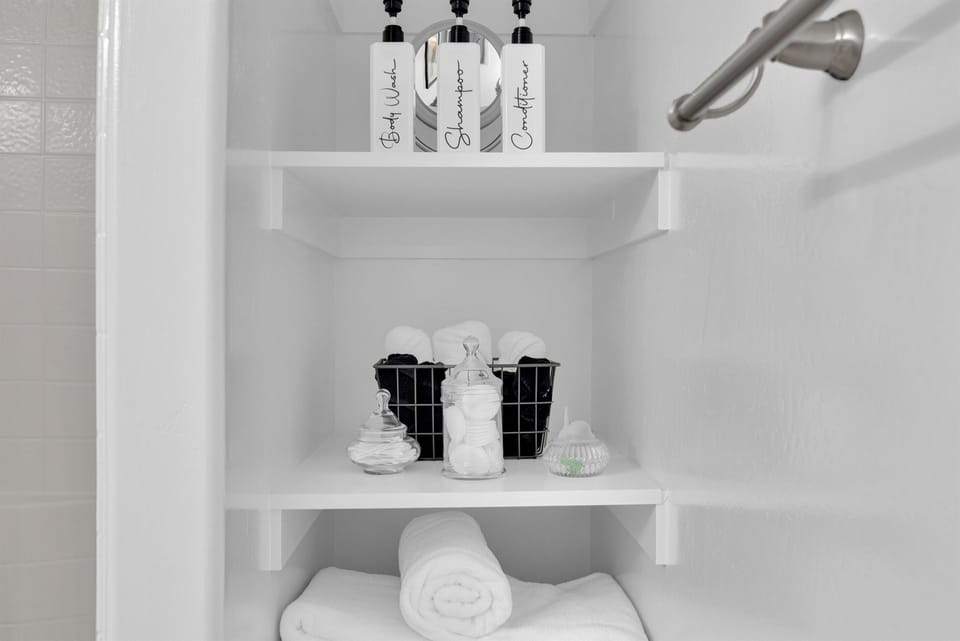 Toiletries provided. Shampoo, conditioner, body wash, and plenty of white fluffy towels.