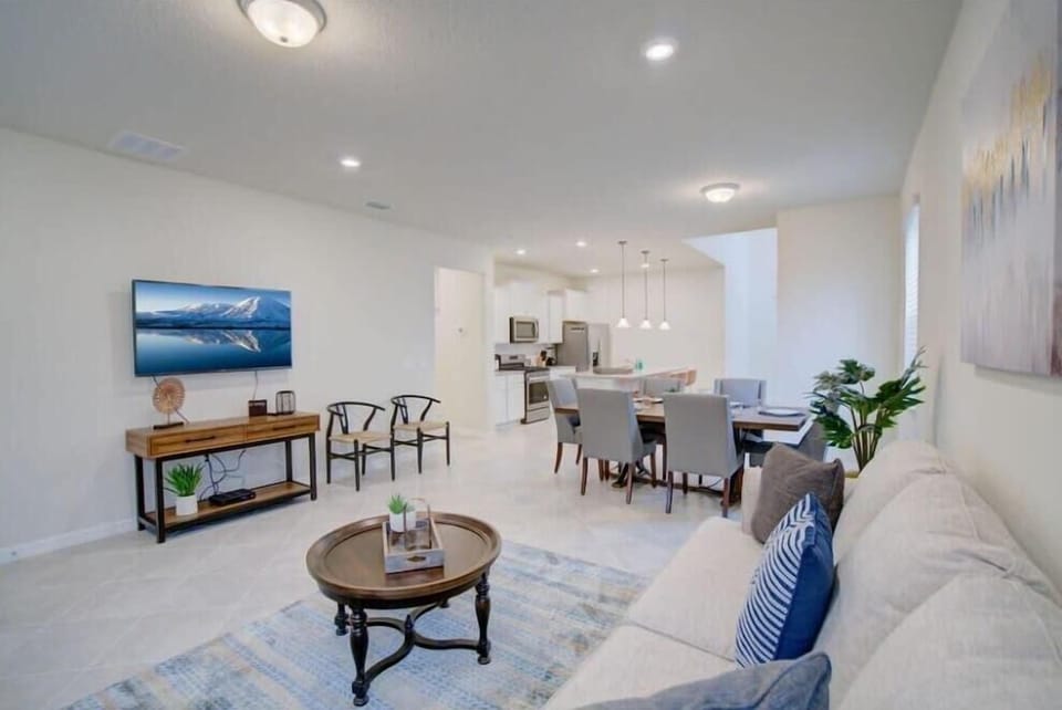 Spacious open-plan living and dining area with modern amenities and stylish decor, perfect for relaxation and entertaining.