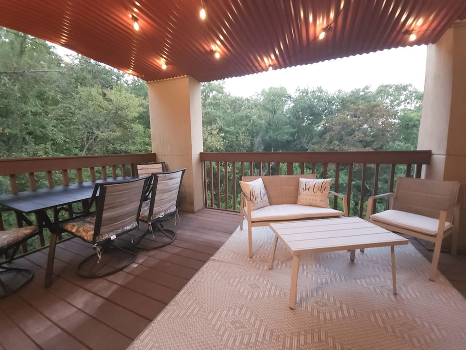 Oversized patio with multiple areas to relax and play.