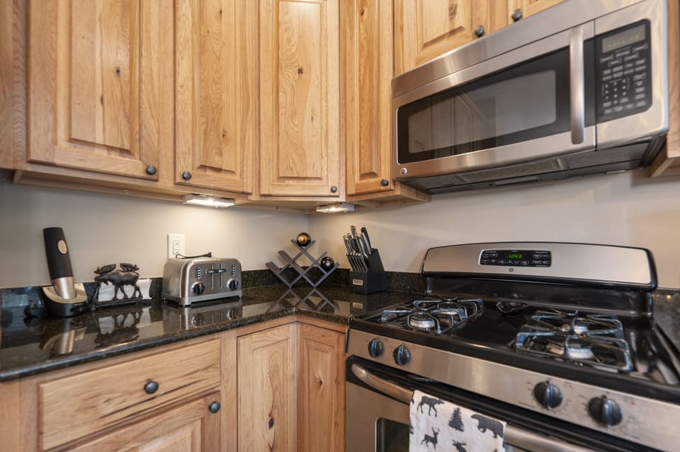 - Gas range and microwave with ample counter space   - Wood cabinetry adds rustic warmth to the kitchen   - Convenient cooking area ready for every meal