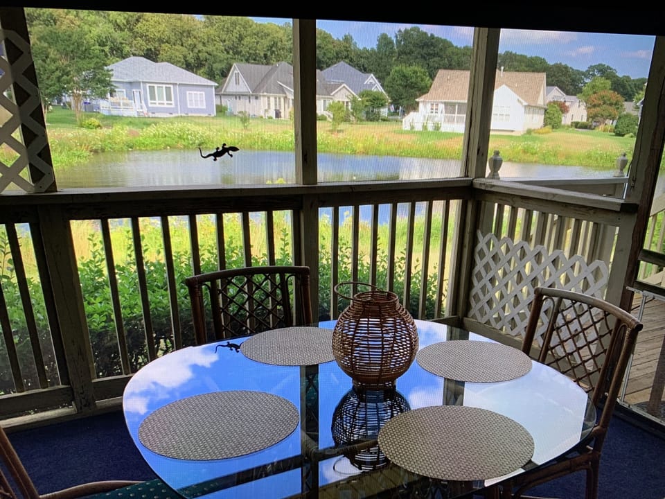 Screened-in porch provides space to dine outdoors.