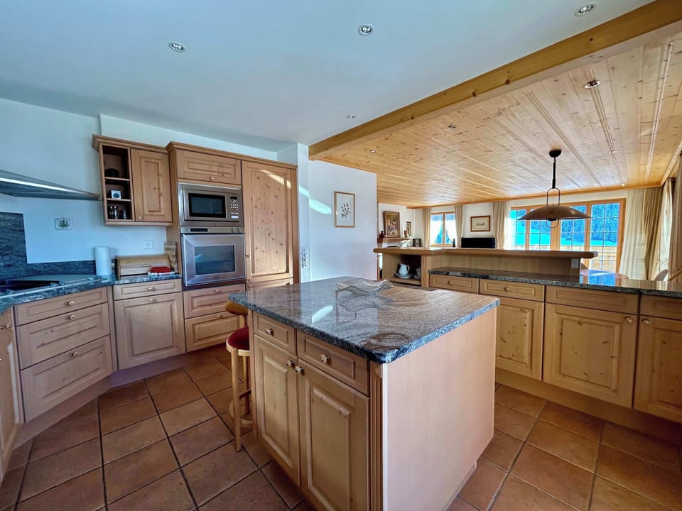 spacious kitchen with kitchen island and bar table 