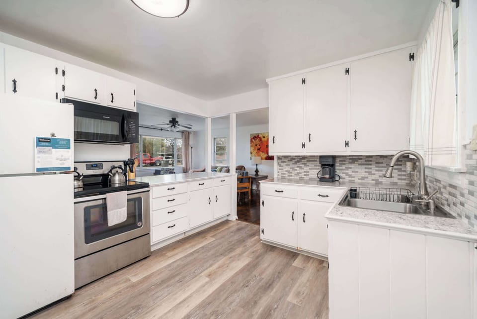 Kitchen with great countertop space for preparing your meals. Open view to the living room and dining room to stay connected with the rest of your group while cooking.