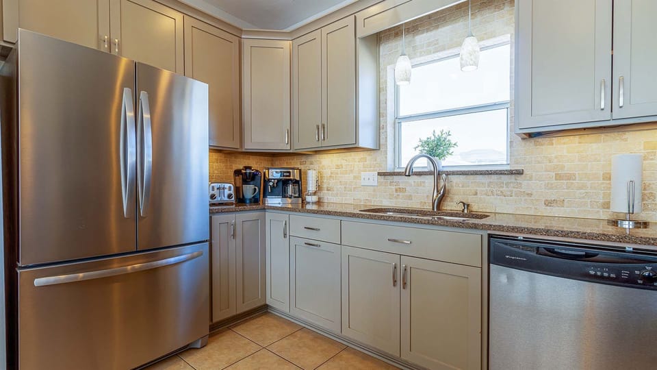 Beautiful countertops, stainless steel appliances, dishes, glasses, pots, pans, Cuisinart knives, Cuisinart griller, and everything you’ll ever need.