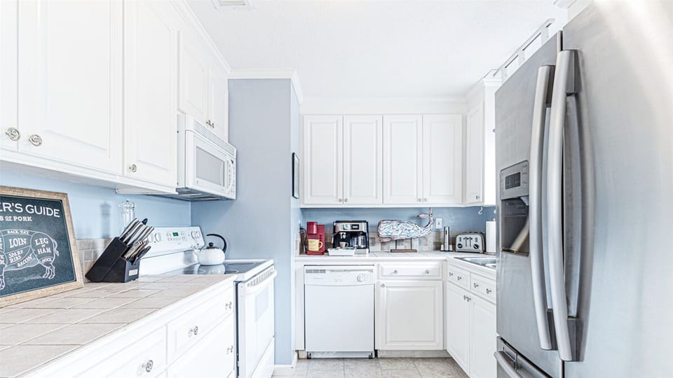 Modern kitchen completely outfitted with all you could need of appliances and utensils.