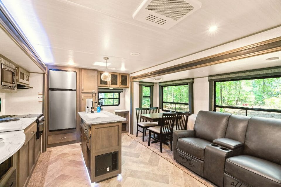 The Moto Ranch at Croom Vacation rentals The MX 1 bedroom 1 bath sleeps Three. kitchen, 3 burner propane stove, fridge/freezer, microwave, sink with cutting board cover. tv, and electric fireplace dining table, reclining chairs