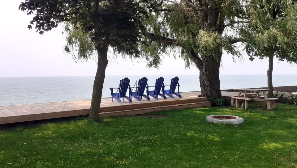 Spacious waterfront yard with 40 foot deck, picnic table and firepit.