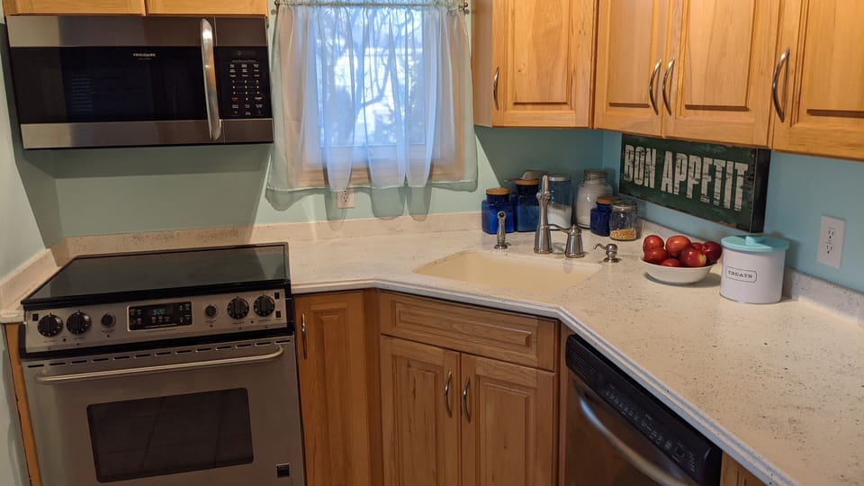 Kitchen- stove, dishwasher, fridge and microwave.