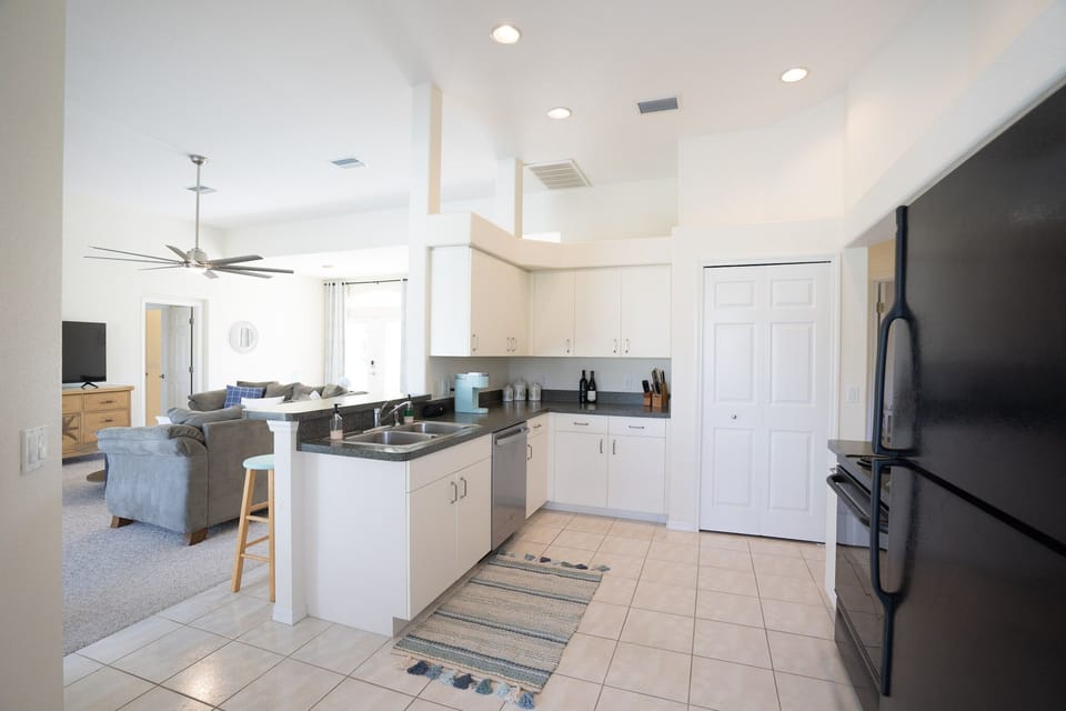 Open kitchen that looks out over the family room and pool