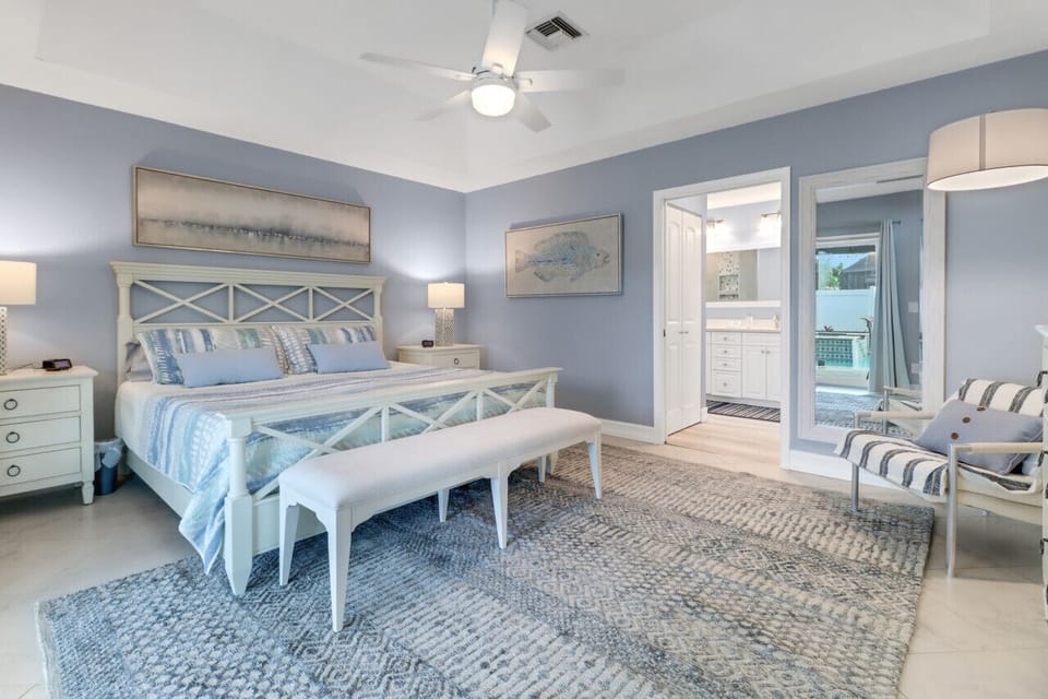 Master bedroom with split-king adjustable bed, comfy chair, and private bathroom.