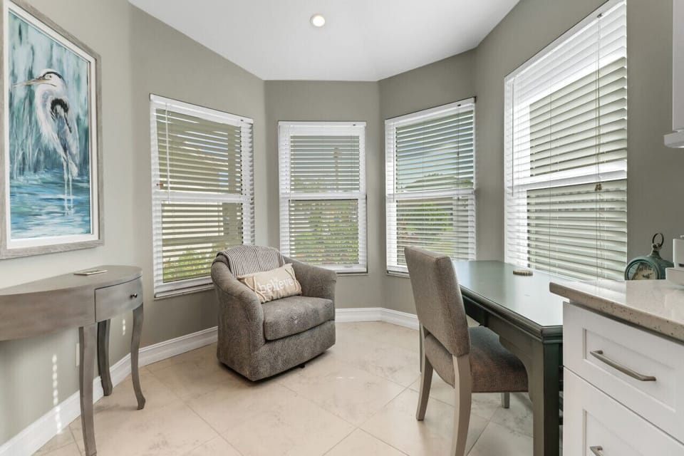 Office nook off kitchen with comfy reading chair.