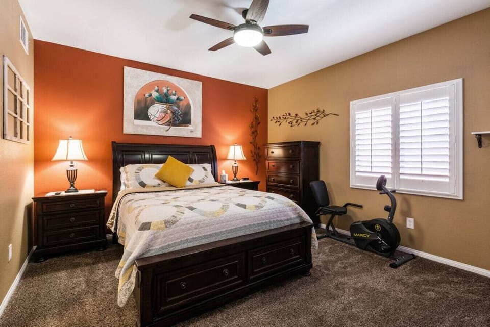 Primary bedroom with recumbent bike and attached bath.