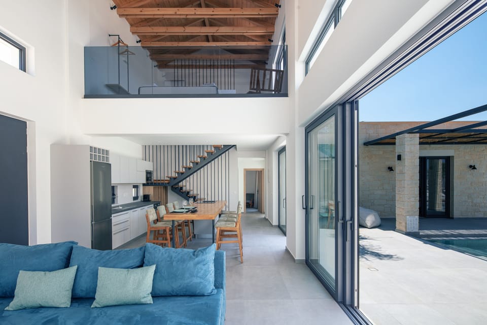Open-plan layout connecting the living room, kitchen, and pool terrace.