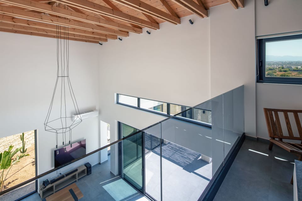 Chic interiors with natural colors, wood details, and modern furniture.