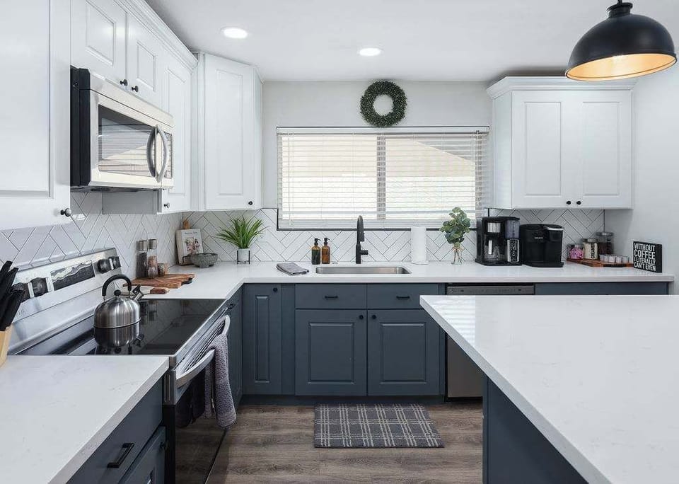 Open concept kitchen with stainless steel appliances, breakfast bar island seating, tons of natural light, and fully stocked with your basic cooking essentials.