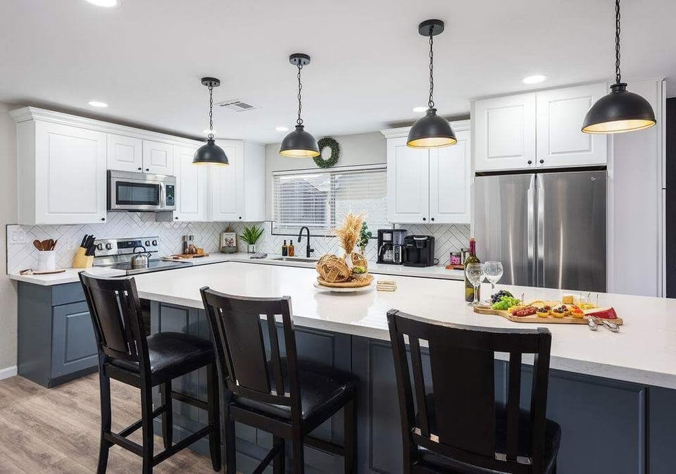 Open concept kitchen with stainless steel appliances, breakfast bar island seating, tons of natural light, and fully stocked with your basic cooking essentials.