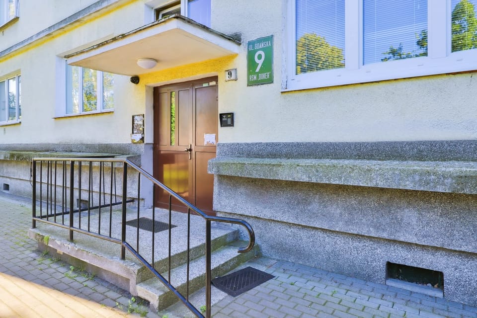 The main entrance of the building with a ramp for easy access and a clean, welcoming design.
