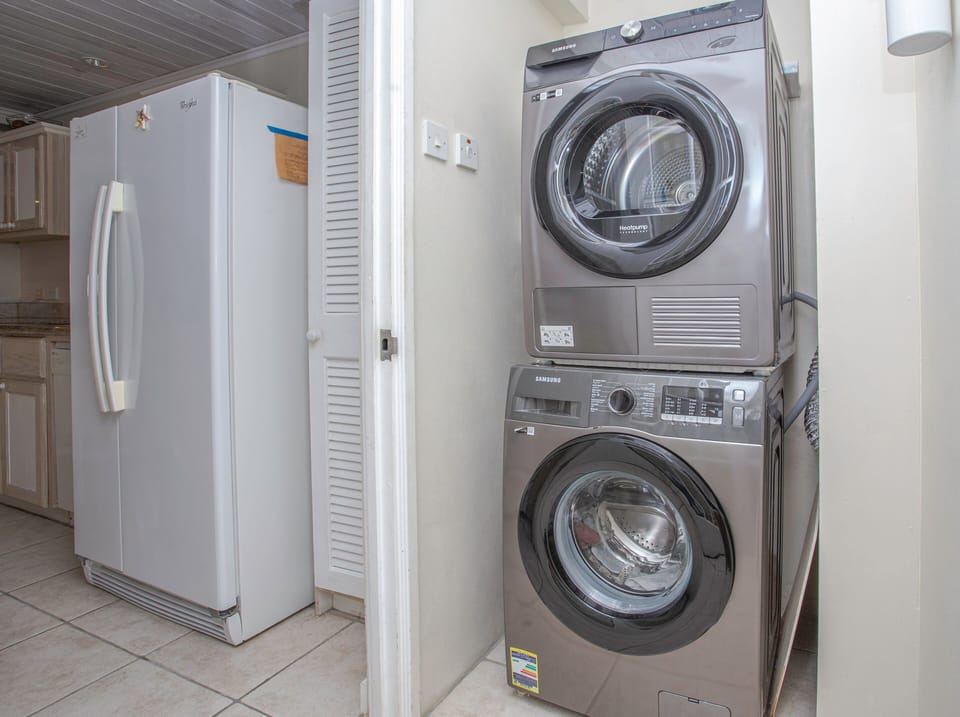 Laundry area in the unit with washer and dryer.