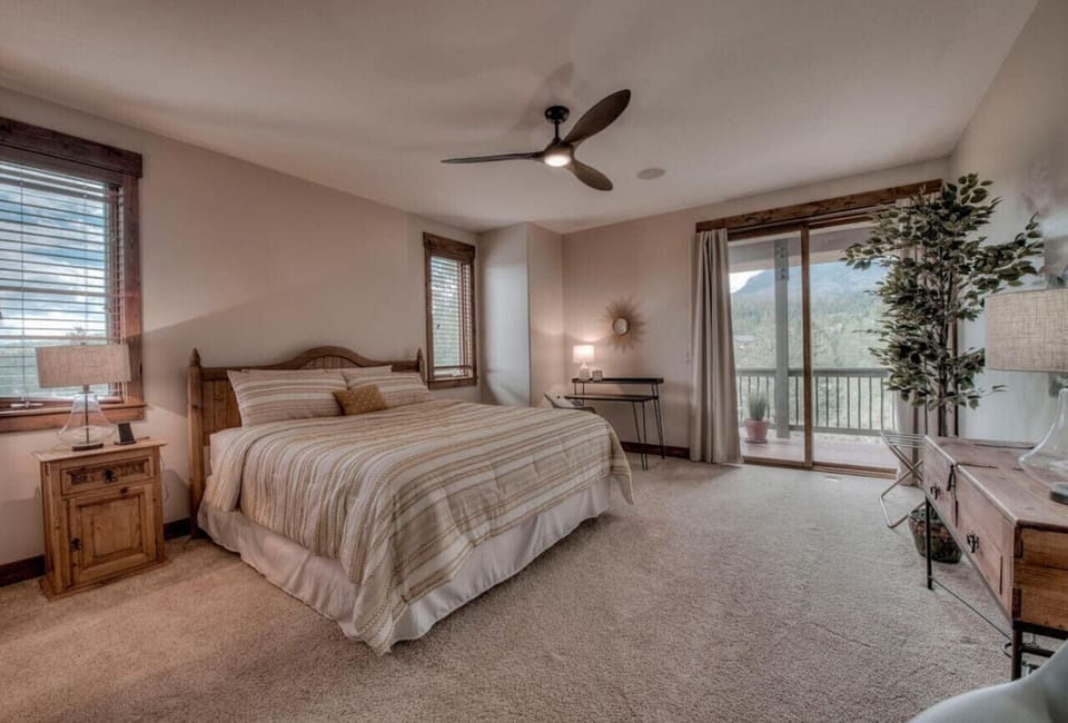 Spacious king bedroom with doorway to deck.