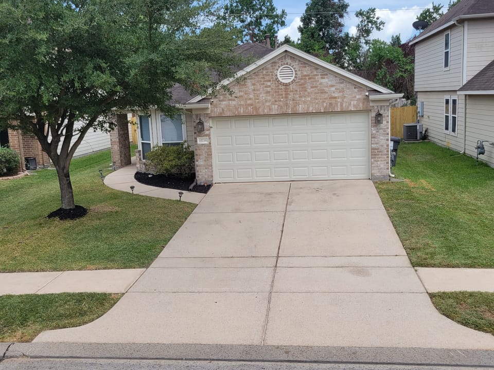 Front view of house has a 2 car driveway for parking and free street parking.