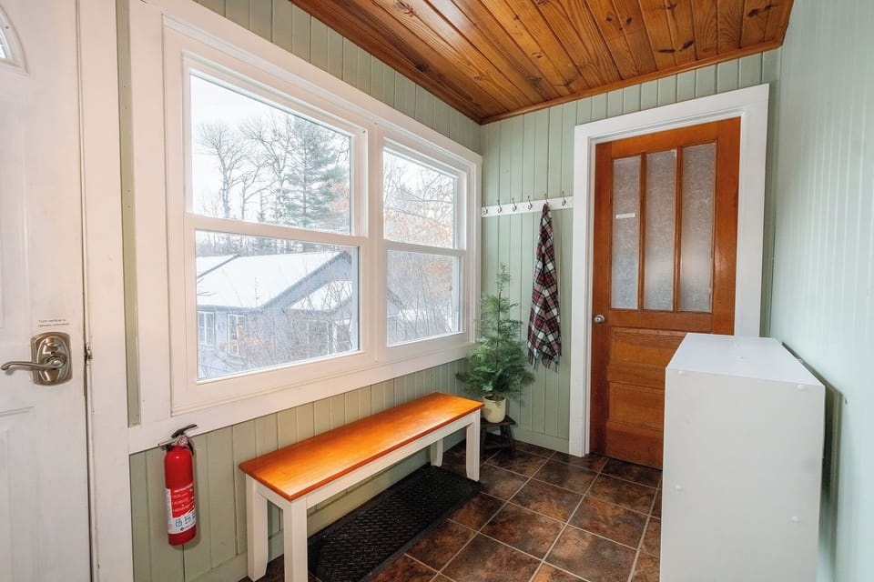 Front entryway to the laundry room (brown door) and kitchen.