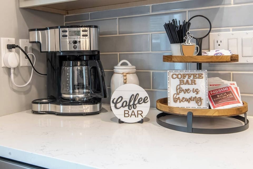 Coffee bar fully stocked with hot chocolate, tea, coffee, sugar, and creamer.