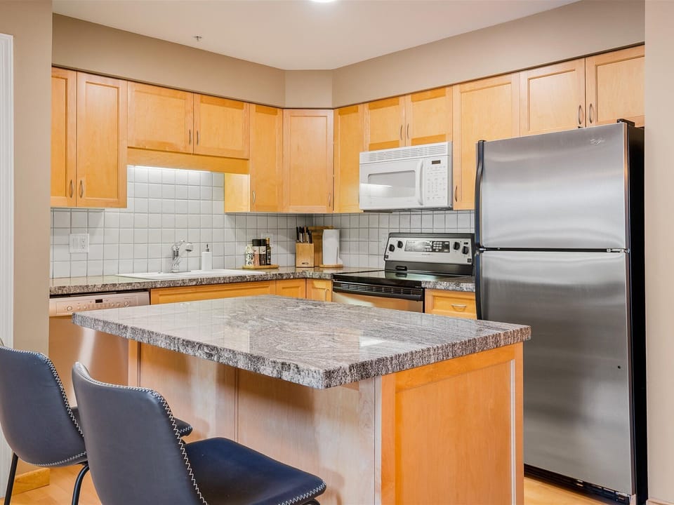 Kitchen - Fully stocked with everything you may need for home cooking, island and bar stools for a quick morning breakfast