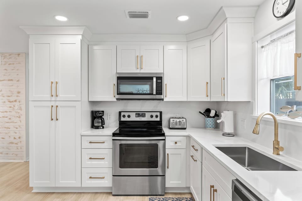Kitchen is fully equipped and features stainless steel appliances.