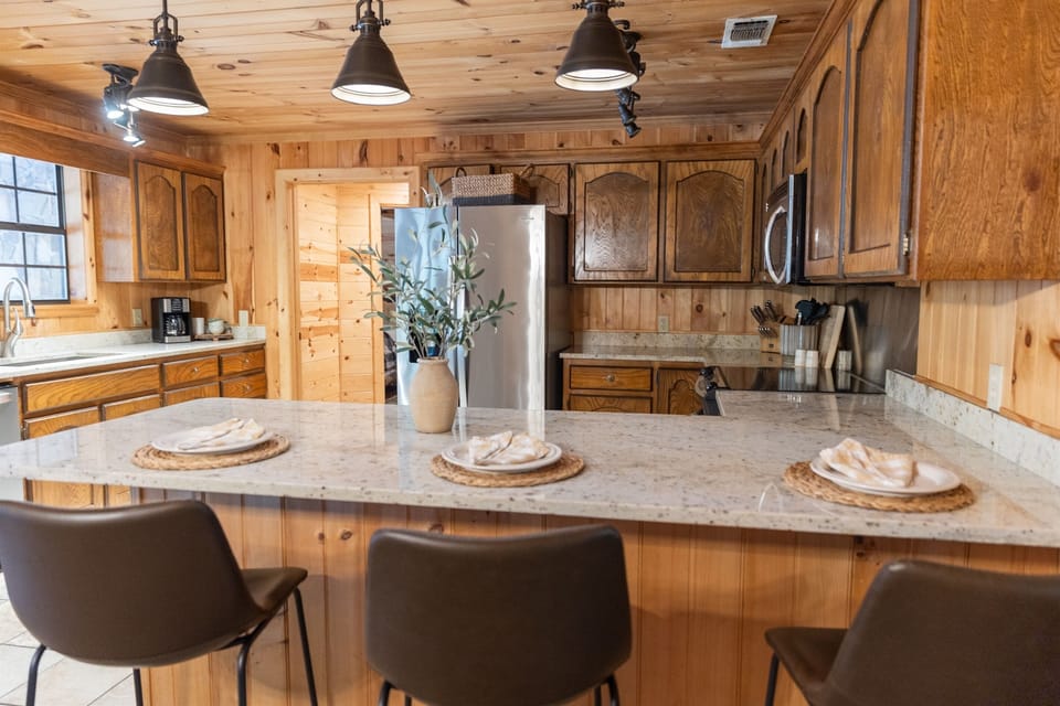 This cozy dining nook is bathed in natural light, perfect for enjoying the forest views.