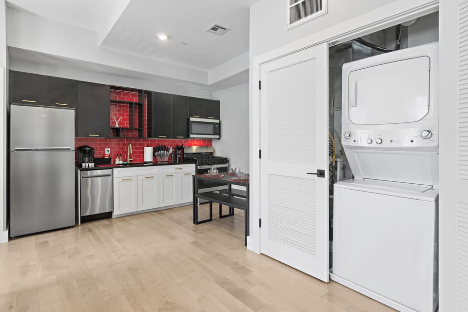 Fully-equipped kitchen with modern stainless steel appliances, ample countertop space, and a wide range of cookware, ensuring a seamless cooking experience for all your culinary needs.