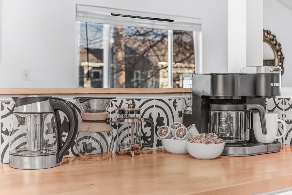 The deluxe coffee bar includes a Keuirg, drip coffee, French press, pour over coffee, and a tea kettle