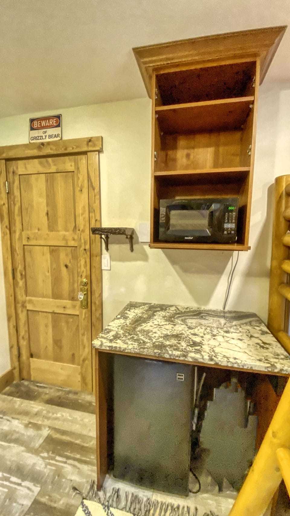 Microwave, small fridge (has a freezer) and table located in the 2nd bedroom.