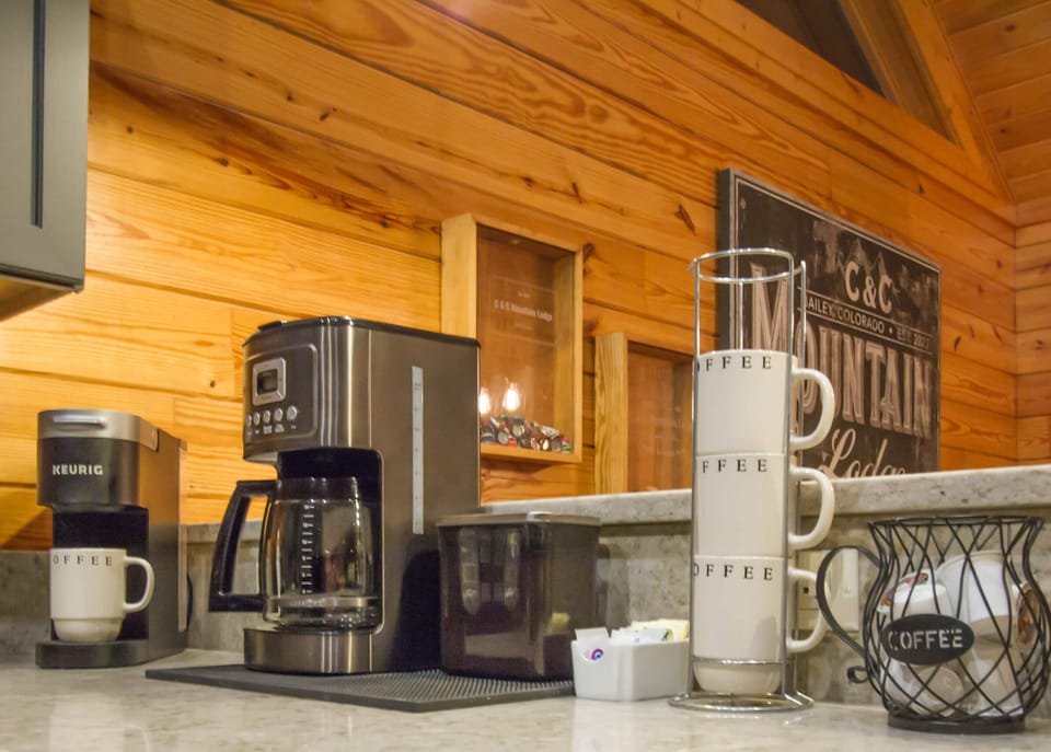 Traditional coffee maker and Keurig coffee maker.  Coffee and tea proved.