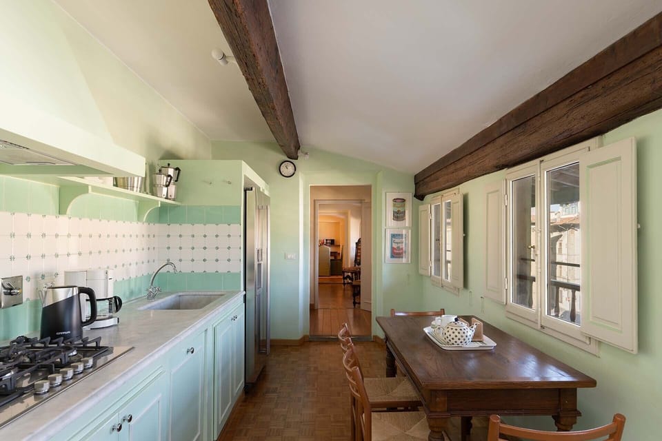 Fully equipped kitchen with table for extra space or casual dining.