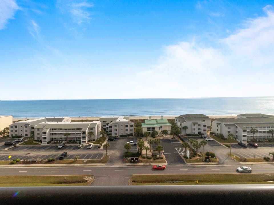 Beachfront resort complex with ocean views and convenient parking, located steps from the sandy shore.