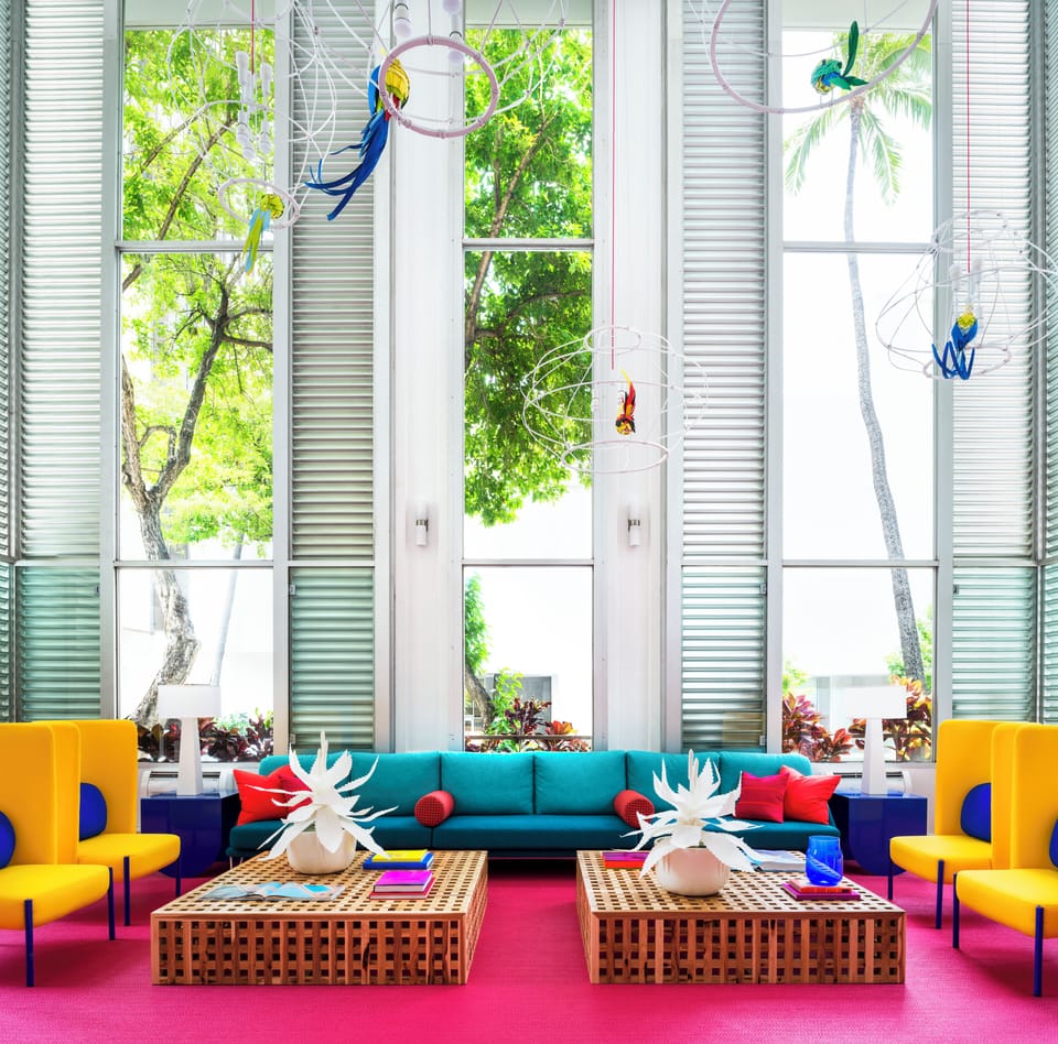 Gather on bold sofas in a sunlit, design-forward lounge.