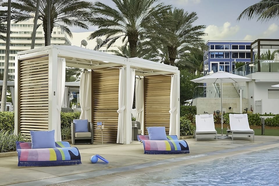 Soak up sunshine on plush daybeds beside the sparkling pool.