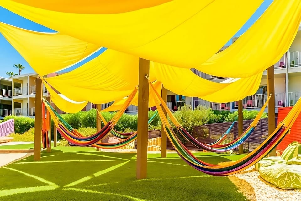 Lounge beneath golden shade sails and sway in breezy hammocks.
