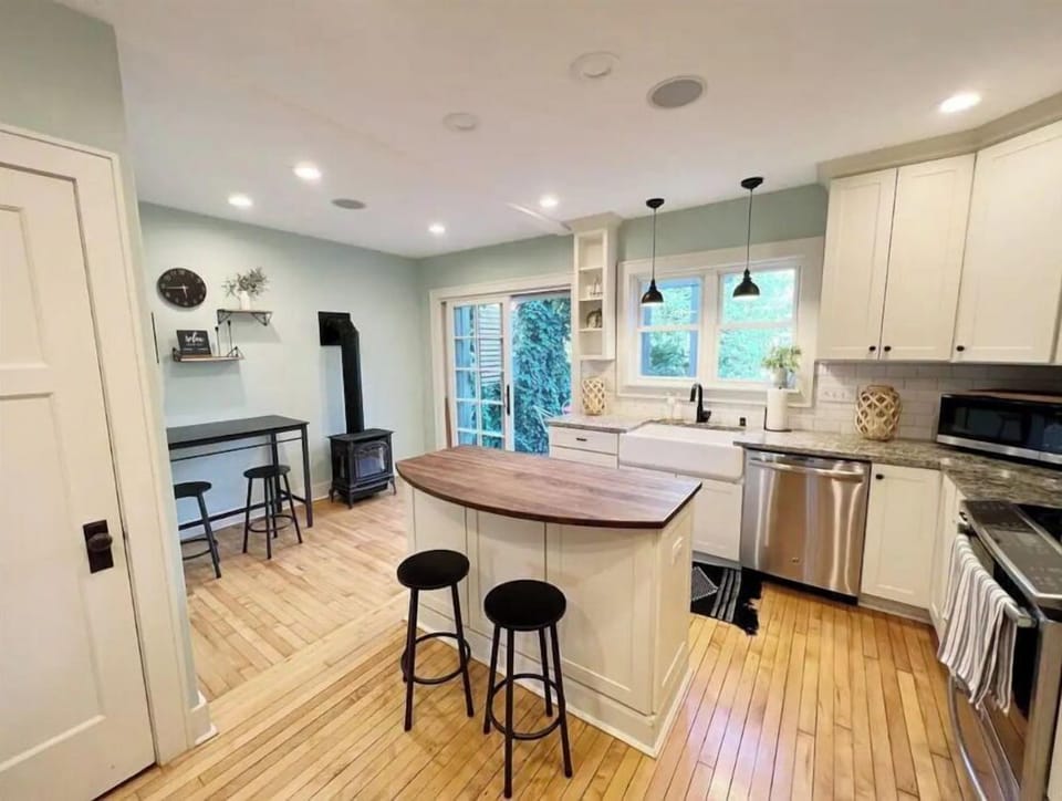 Spacious kitchen with breakfast bar, island and electric fireplace.