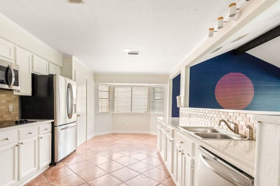 The large kitchen opens to the dining and living areas.