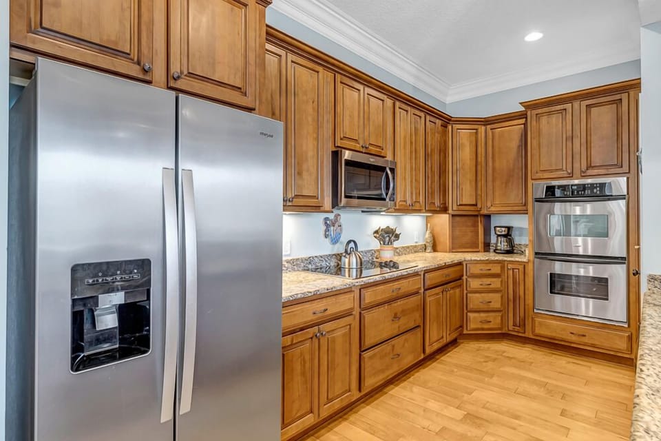 Fully Equipped Modern Kitchen - - Fully stocked kitchen with stainless steel appliances and rich wood cabinetry
- Features granite countertops, double oven, and deep sink for easy meal prep
- Warm, functional space for cooking, snacking, or holiday feasts