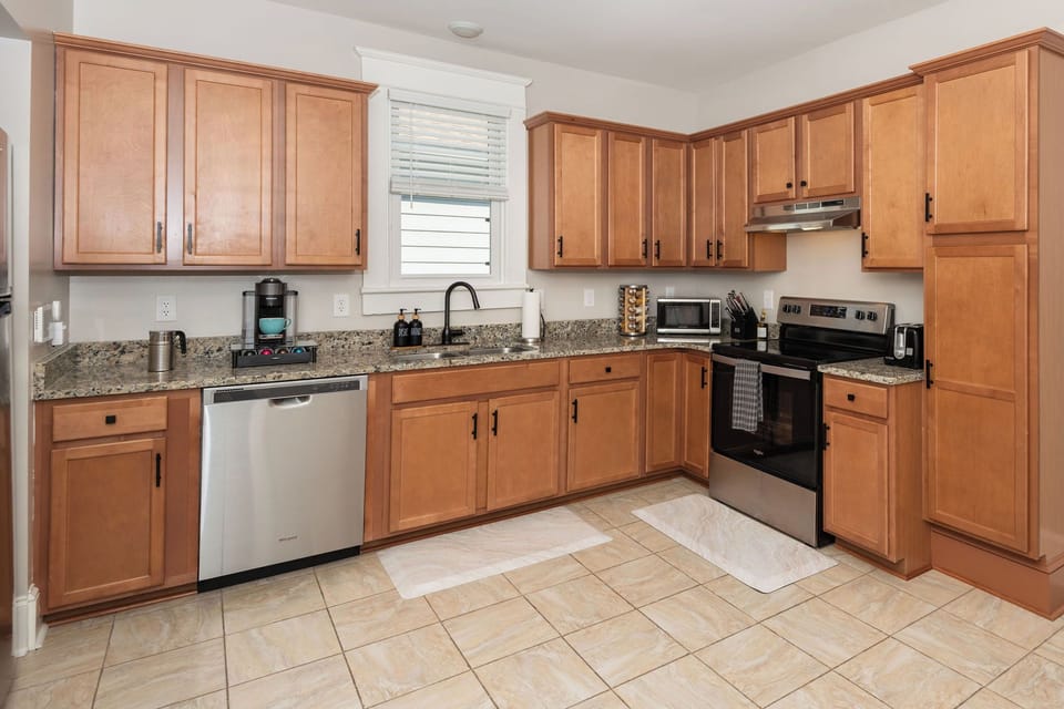 Full Size Kitchen with fridge, dishwasher, stove, oven, microwave, and coffee machine. (2)