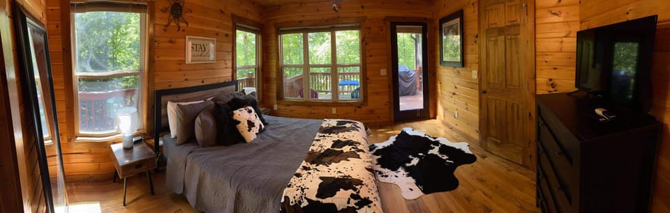 Main level bedroom with queen bed and private bathroom